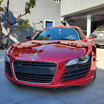 A red sports car parked in sunlight